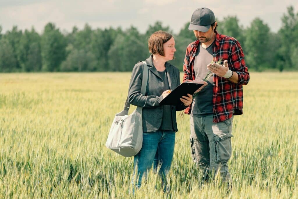 Mortgage loan officer assisting farmer in financial allowance application process